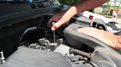 Mechanic removing a spark plug from an engine Stock Footage 25571586