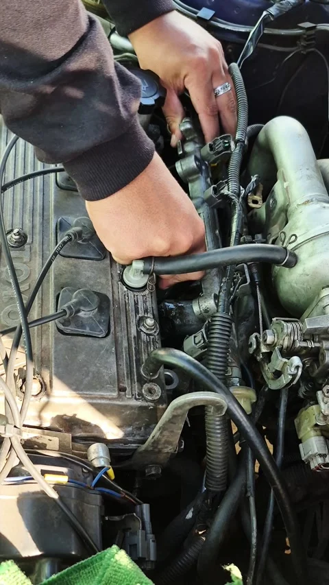 Mechanic Removing Spark Plug Wires from Toyota Engine in Asuncion Paraguay Video stock 335476133