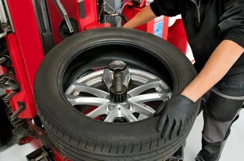 Mechanic Removing Tire From Wheel At Workshop Stock Photos