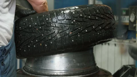 Mechanic Removing Wheel From Car During Tire Replacement Stock Footage 337829591
