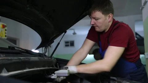 Mechanic repairing car engine Stock Footage 70589582