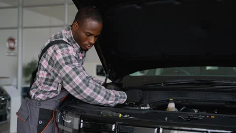 Mechanic repairing car engine in garage Stock Footage 300608403