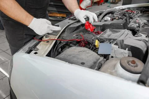 Mechanic repairing engine on a car using wrench. Close up of hands Stock Photos