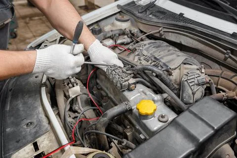 Mechanic repairing engine on a car using wrench. Close up of hands Stock Photos