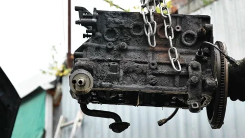 Mechanic repairing old engine block with chains and tool Video stock 319403618