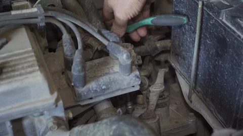 A mechanic is repairing something in a car engine Stock Footage 126146431