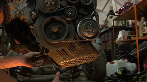 Mechanic repairs and installs an old gray car after a road accident Stock Footage 297686830