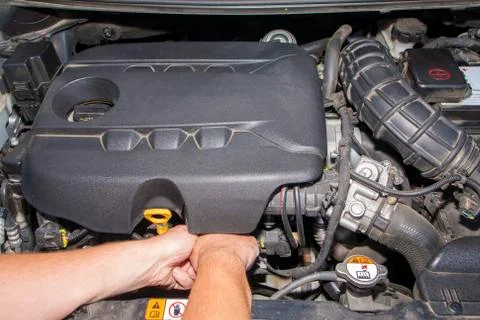 Mechanic repairs car engine Stock Photos