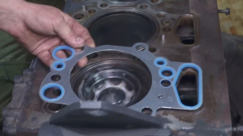 Mechanic repairs the engine and changes the gaskets Stock Footage 105280274