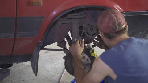 A mechanic repairs the engine and chassis of a car at a service station Video stock 110863569