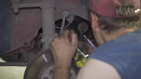 A mechanic repairs the engine and chassis of a car at a service station closeup Stock Footage 110863658