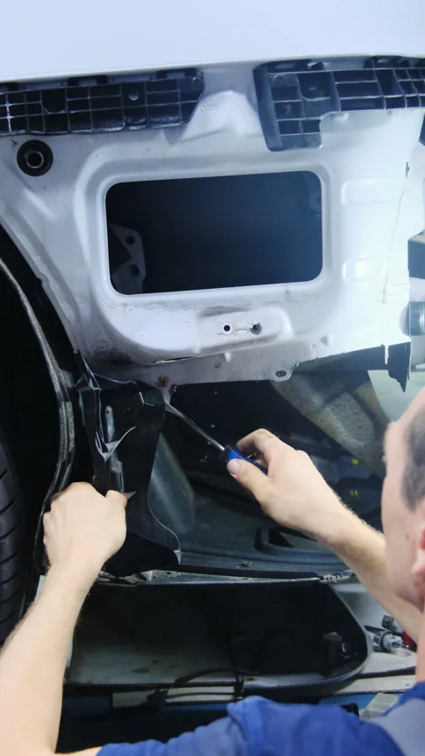 Mechanic repairs inside of rear panel of vehicle body Stock Footage 317652411