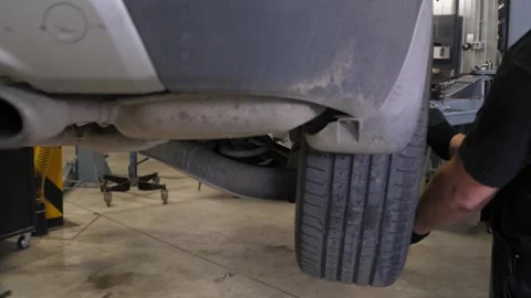 A mechanic repairs the wheels of a car at a service station. Stock Footage 337220901