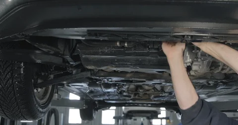 Mechanic Replace Old Oil Filter Of Modern Car Stock-Footage 124961812