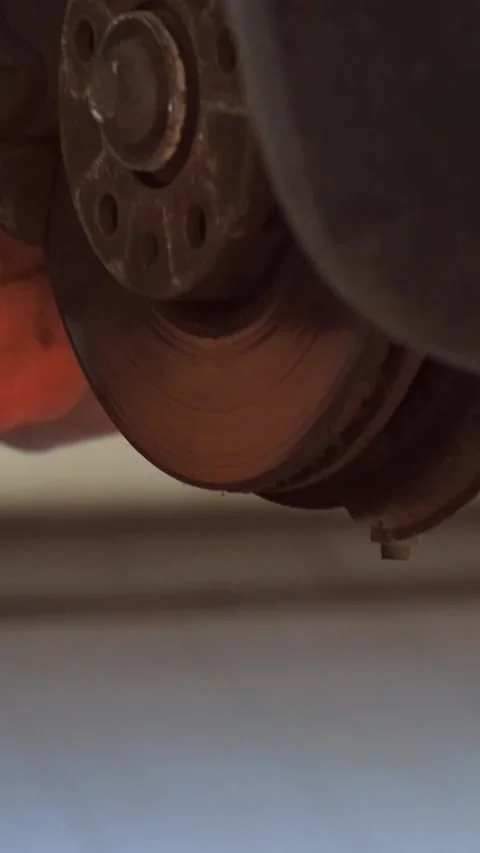 Mechanic replacing brake disc and pads on car in garage Stock Footage 332858373