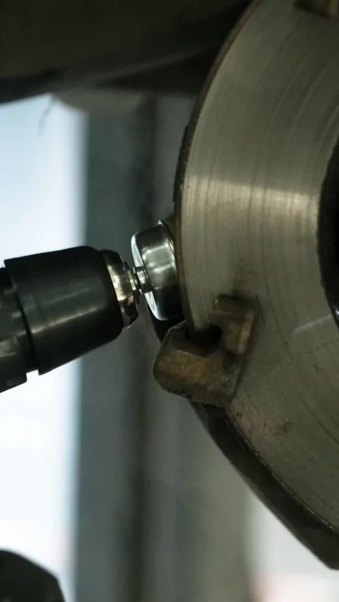 Mechanic replacing brake disc and pads on car in garage Stock Footage 332858377