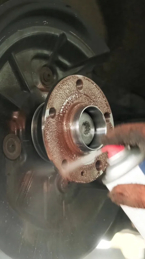 Mechanic replacing brake disc and pads on car in garage Stock Footage 332858401