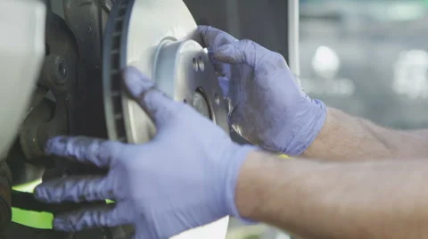 Mechanic replacing a brake disc in slow motion Stock Footage 49241032