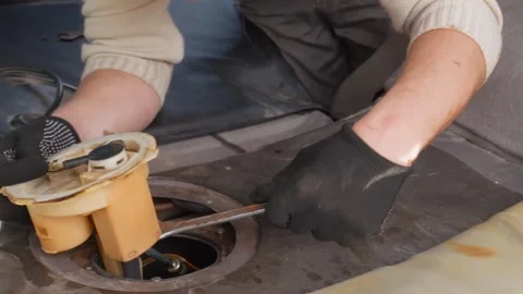 Mechanic replacing a car fuel pump Stock Footage 322645086