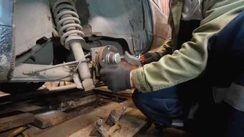 Mechanic replacing old rusty car brake disc Stock Footage 326142166