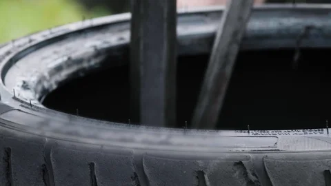 Mechanic replacing used torn tire from a rim on machine-tool close-up Stock Footage 129313115