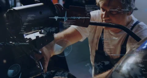Mechanic responding to gauge, adjusting engine bolts in workshop while HUD Stock Footage 333833821