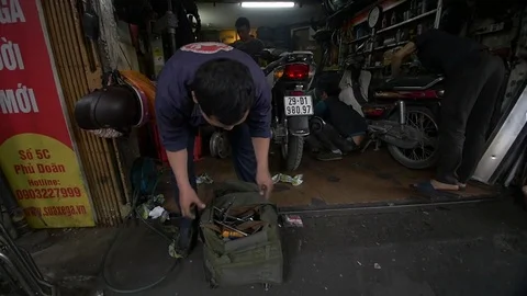 Mechanic rummages through bag of tools Stock Footage 70610594