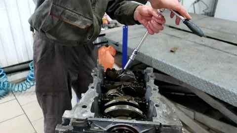 The mechanic screws the connecting rods with a ratchet wrench Stock Footage