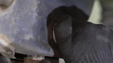 Mechanic screws a nut onto an eccentric suspension alignment bolt. Stock Footage 345911972