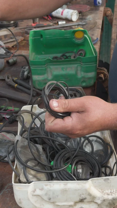 Mechanic selecting rubber o rings for engine repair Stock Footage 339038193