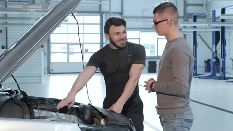 Mechanic shows problems of the car to the client Stock Footage 251113676