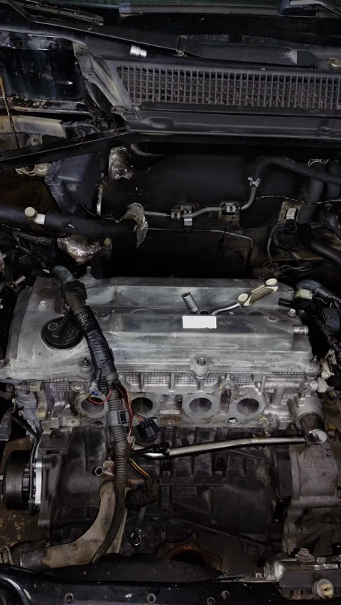 Mechanic socket wrench lying on a silver car engine valve cover Stock Footage 340415353