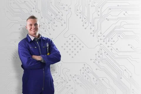 Mechanic standing in front of a circuit board background Stock Photos