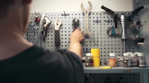 Mechanic is taking tool from tool wall Stock Footage 51542260