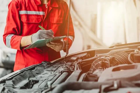 Mechanic team check list engine repair maintenance oil liquid change at fro.. Stock Photos