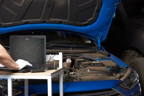 Mechanic testing car engine Stock Photos