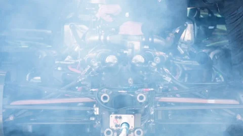 Mechanic testing new engine mounted in the car Stock Footage 108580389