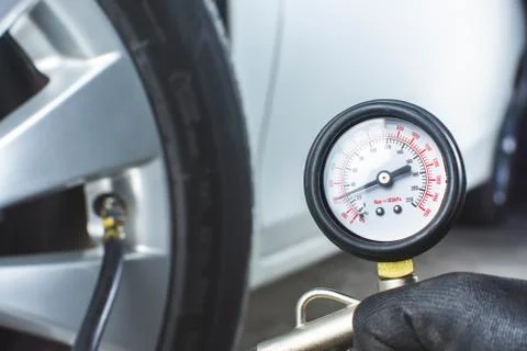 Mechanic testing the tire pressure Stock Photos