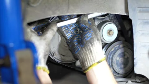 Mechanic Tightening Bolt on Engine Component using Wrench, The video shows Stock Footage 346121012
