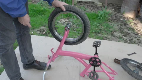 Mechanic Tightening the front  Wheel Nut bicycle Stock Footage 252126176