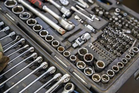 Mechanic tool set with ratchets sockets bits and wrenches in auto repair shop Stock Photos
