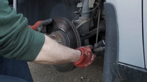 The mechanic tries to remove the wheel drive to replace it Stock Footage 108974810
