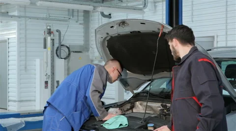 Mechanic troubleshoots car problem at the car service Stock Footage 63034035