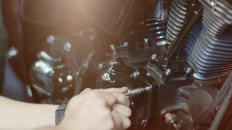 The mechanic is twisting bold in a motorcycle 動画素材 120608899