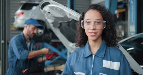 Mechanic in uniform talking explain to camera about repairing car service Stock Footage 157625508