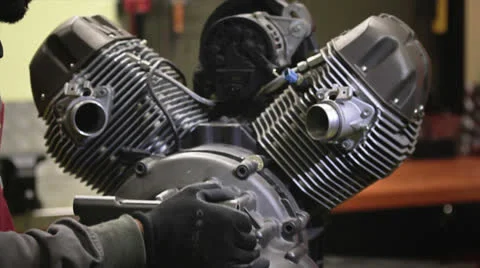 Mechanic unmounts the engine of the motorcycle Stock Footage 24492900