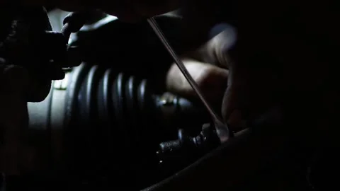 Mechanic unscrews a replacement part during car maintenance Stock Footage 148264170