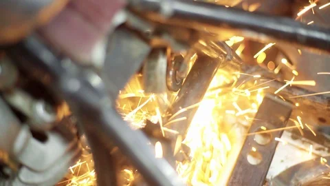 Mechanic use angle grinder machine on motorcycle metal frame Stock Footage 128920684