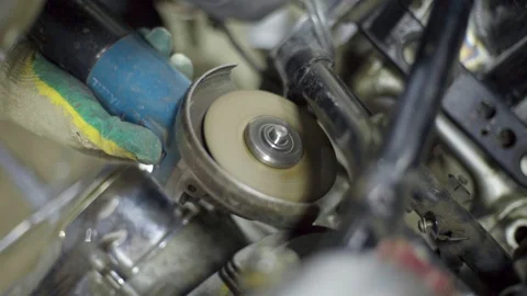 Mechanic use angle grinder machine on motorcycle metal frame Stock Footage 128920736