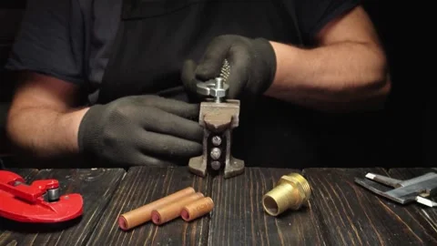 Mechanic uses hand tools to assemble metal components on a wooden workbench, Stock Footage 334632141